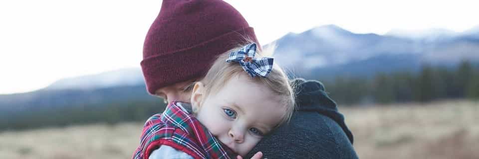 a parent holding a child